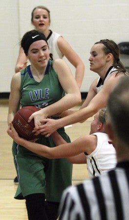 Lyle-Pacelli’s Lucy Nelson fights for a loose ball against Spring Grove in Lyle Thursday. Photo by Colleen Nelson