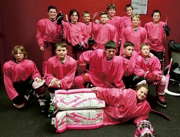 The Austin Squirt B's played their Pink Game Saturday Dec. 16 defeating Red Wing. After the game they auctioned off their jerseys raising $2,325 for the Hormel Institute. Photo Provided