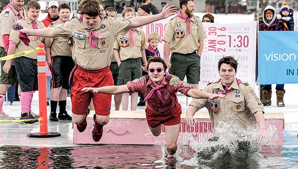 Members of Boy Scout Troop 113 Jacob Langstaff, from left, Sam Hagen and John Olson head into the water during the Polar Plunge Saturday afternoon in East Side Lake. -- Photos by Eric Johnson/photodesk@austindailyherald.com