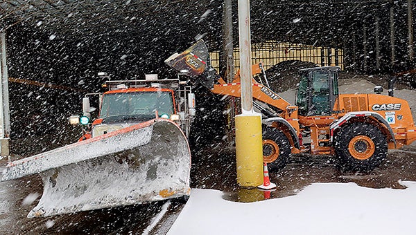 A loader fills a plow with salt at MnDOT’s truck station in St. Paul on Tuesday.  -- Elizabeth Dunbar/MPR News