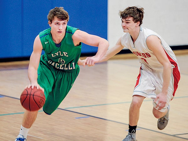 Lyle-Pacelli’s Jordan Cotter hurries the ball up court against Houston’s Austin Peplinski during the first half Friday night in Lyle. Eric Johnson/photodesk@austindailyherald.com