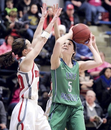 Lyle-Pacelli’s Bethany Strouf turns to shoot in a crowd in teh second half against Houston Friday night in Lyle. Eric Johnson/photodesk@austindailyherald.com
