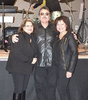 Denny Charnecki of The DC Drifters poses Saturday at the Surf Ballroom in Clear Lake, Iowa, with Erma Valens, left, and Connie Valens, right, who are both members of the Richie Valens’ family.  Photos provided