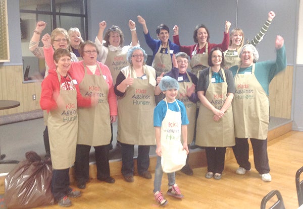 Members of Zonta celebrate after packaging food packs. Photos provided