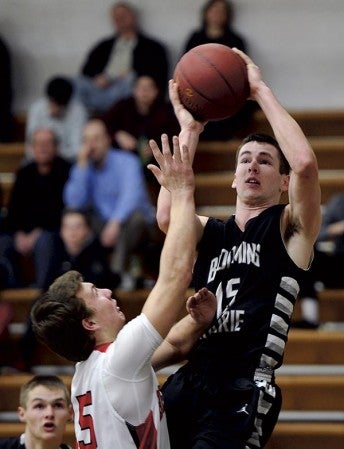 Blooming Prairie’s Anthony Nelson pulls up for a shot over the defense of Ben Jandro of Faribault Bethlehem Academy in Blooming Priarie Monday. Rocky Hulne/sports@austindailyherald.com