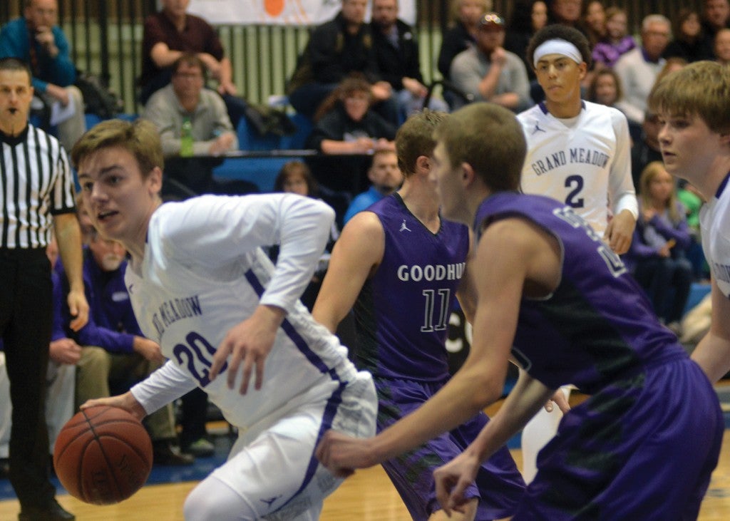 Grand Meadow’s Michael Stejskal handles the ball in the paint against Goodhue in Mayo Civic Center Saturday. Rocky Hulne/sports@austindailyherald.com