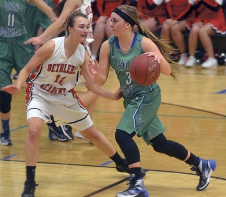 Lyle-Pacelli’s Courtney Walter dribbles past FBA’s Hannah Rob in Lyle Gym Thursday. Rocky Hulne/sports@austindailyherald.com