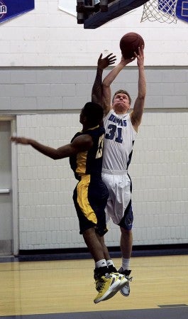 Riverland’s Marcus Wynn shoots over RCTC’s Aaron Samuels in Riverland Gym Wednesday. Rocky Hulne/sports@austindailyherald.com
