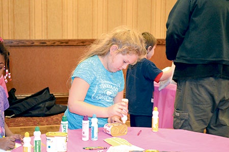 Ariel Anhalt works on crafts at the Hormel Historic Home Saturday during the Spam Kids Festival. Ariel came with her dad Randy, mom Anita and brother Ashton. The festival sought to teach kids about Spam and get families involved in the Hormel Historic Home.