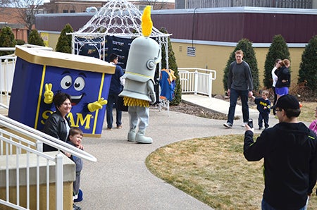 People get their picture taken with Spammy at the Hormel Historic Home Saturday during the Spam Kids Festival.