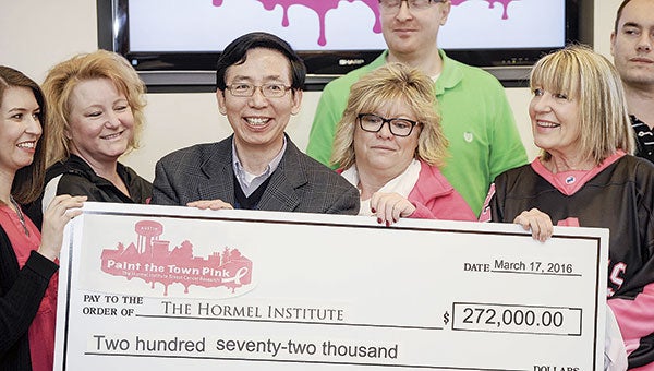 The Hormel Institute Executive Director Dr. Zigang Dong was all smiles Thursday morning as the final total of $272,000 was announced from this year’s Paint the Town Pink.  Eric Johnson/photodesk@austindailyherald.com