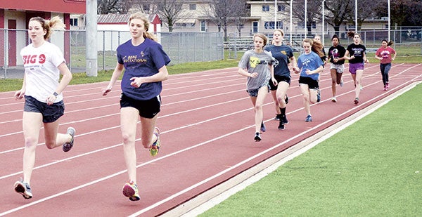 Madison Overby and Abby Lewis lead a pack of Austin runners at practice in Larry Gilbertson track and field Tuesday. 