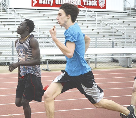 Ochan Ochogi, left, and Trent Brown, hustle down the finish line at Austin Packer track and field practice at Larry Gilbertson track Tuesday.