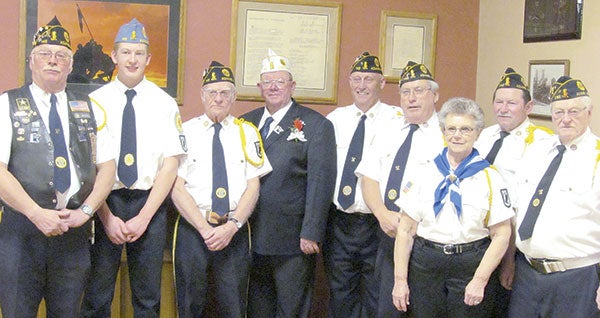 Kellogg, center, poses with the colorguard during the banquet in Adams. Pictured, from left, are Dennis Lewison, Brady Kiefer, “Peewee” Landherr, Jim Kellogg, Wayne Robertson, Dave Whalen, Liz Kiefer, Fred Harvey and Cliff Kiefer. 
