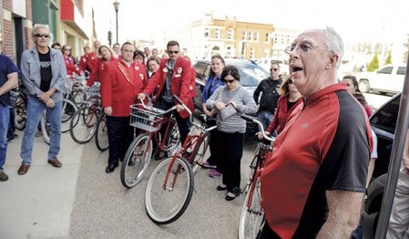 Steve Kime, chair for the Vision 2020 Bike/Walk Committee speaks Friday at the ribbon cutting and official launch for the Red Bike Program outside Rydjor Bike Shop. Eric Johnson/photodesk@austindailyherald.com