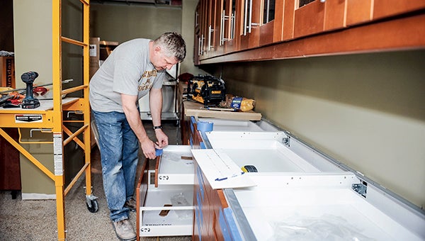 Mike Sasse works on drawers in the back of Willow Pet Hospital Friday afternoon. The vet clinic is soon to open in Austin.  Photos by Eric Johnson/photodesk@austindailyherald.com