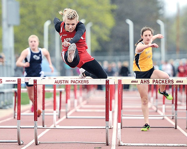 Austin’s Rachel Quandt heads toward a win in her heat of the 100-meter hurdles Tuesday at Larry Gilbertson Track and Field. Eric Johnson/photodesk@austindailyherald.com