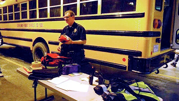 Police chief and ambulance director Mike Gehrke demonstrates EMS equipment set up for this type of incident during a training program for bus accidents. -- Photo provided