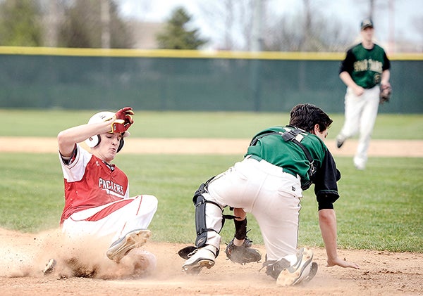 Austin’s Alex Ciola scores when Rochester Mayo catcher Alex Prindle can’t come up with the ball Thursday afternoon in game one of a doubleheader at Dick Seltz Field. Eric Johnson/photodesk@austindailyherald.com