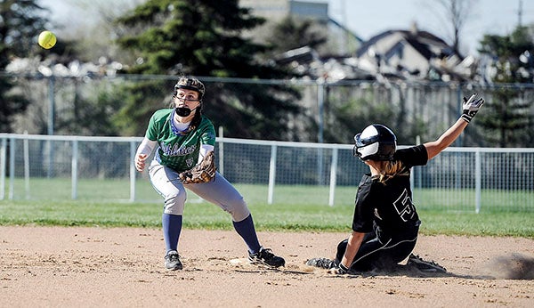 Lyle-Pacelli’s Abby Bollingberg waits for the ball on a stolen base attempt by Blooming Prairie’s Abby Wayne during the Packers Invite Friday at Todd Park. Eric Johnson/photodesk@austindailyherald.com