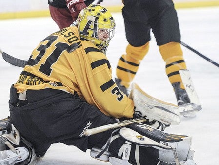 Austin’s Kristofer Carlson turns to find the puck sailing behind him during the first period against Minot in game six of their playoff series last Saturday against Minot. Herald file photo