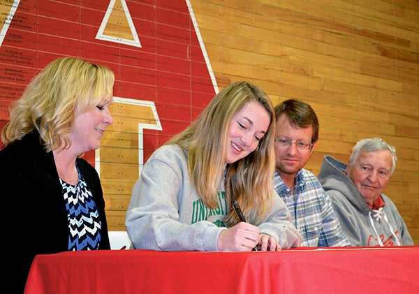 Austin senior Madison Overby signs her national letter-of-intent to run track and cross country at Division I University of North Dakota at Austin High School Wednesday. From left: Sue, Madison, Eric and Rich. Rocky Hulne/sports@austindailyherald.com