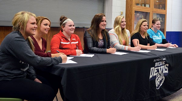 Multiple players signed their national letters-of-intent with the Riverland Community College softball team Wednesday. Left to right: Taylar Larson of WEM, Allison Sharpe of Cold Spring, Jordan Huntley of Austin, Shayla Berkner of Kenyon-Wanamingo, Jess Piel of Austin, Brandi Myers of Austin and Kayla Crowell of Hancock, Minn.. Rocky Hulne/sports@austindailyherald.com