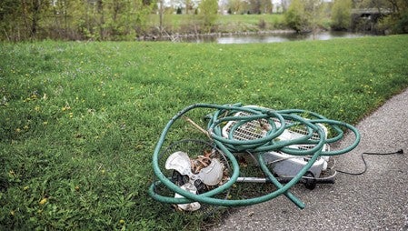 Garbage waits to be picked up along the Cedar River.