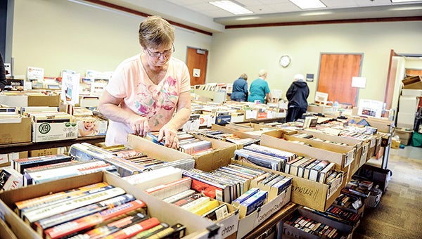 Volunteer Rose McCarthy goes through books as preparations are made for the upcoming used book sale at the Austin Public Library. --  Photos by Eric Johnson/photodesk@austindailyherald.com