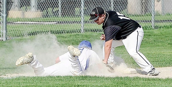 Blooming Prairie’s Riley Olson tags out Hayfield’s Jake Olive who was caught leaning Friday afternoon in Blooming Prairie. Eric Johnson/photodesk@austindailyherald.com