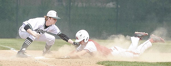  Austin’s Nate Conner slides into third base under the tag of Faribault’s Colton Helgeson Saturday afternoon at Dick Seltz Field. Photos by Eric Johnson/photodesk@austindailyherald.com