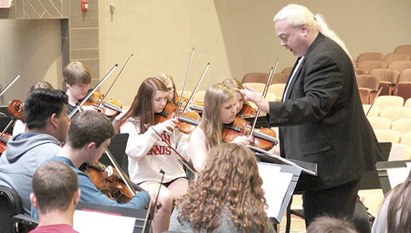 Gene Schott directs the Concert Orchestra in Austin High School’s Knowlton Auditorium Monday. The orchestra program is preparing for its final concert of the year at 7 p.m. Thursday in Knowlton.  Jason Schoonover/jason.schoonover@austindailyherald.com