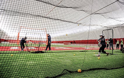 Players from visiting teams in Austin’s winter league make use of the batting cages.