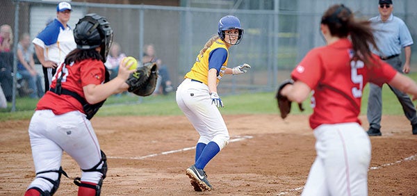Hayfield’s Carrie Rutledge looks back to Bethlehem Academy catcher Grace Viland as she works to try and get out of a rundown in the Section 1A West championship Friday night. Eric Johnson/photodesk@austindailyherald.com