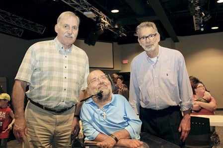 Jim Boohre, left, and Larry Eickman, right, pose with Randy Krulish Monday during an event marking the 50th anniversary of a diving accident that left Krulish as a quadriplegic. Boohre and Krulish helped Krulish for several months with physical therapy after his accident and traveled more than 100 miles each to see him on Monday.  Photos by Jason Schoonover/jason.schoonover@austindailyherald.com