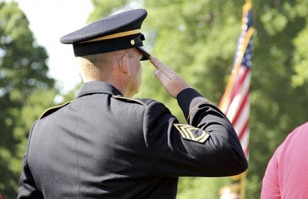Sgt. 1st Class David Gansen of the Austin National Guard Armory salutes during the Memorial Day program at Oakwood Cemetery on Monday.