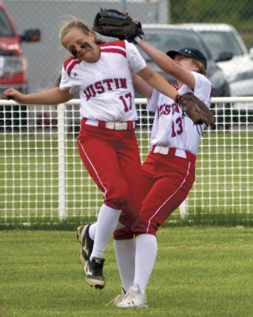 Austin’s Addison Medgarden avoids teammate Hannah Rasmussen as she makes a catch in center field in Todd Park Monday. Rocky Hulne/sports@austindailyherald.com