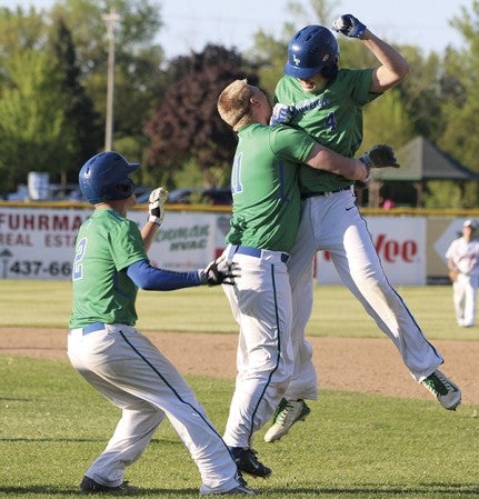 Lyle-Pacelli’s Jordan Cotter, right, celebrates with his teammates Daniel Bollingberg and Braden Kocer after he came up with the game-winning hit in the 10th inning to beat Randolph in Marcusen Park Tuesday. Rocky Hulne/sports@austindailyherald.com