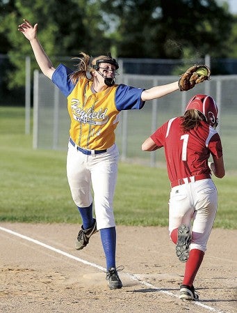 Hayfield first baseman Kate Kruger reaches over Wabasha-Kellogg’s Abbey Graner for the ball in the Section 1A championship at Todd Park Thursday. Eric Johnson/photodesk@austindailyherald.com