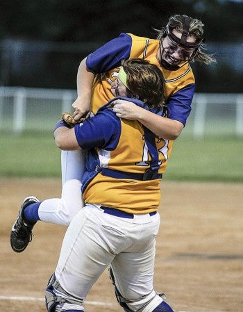 Hayfield catcher Grace Mindrup hoists pitcher Jacinda Gustine after the final out in the Section 1A championship against Wabasha-Kellogg Thursday night at Todd Park. Eric Johnson/photodesk@austindailyherald.com