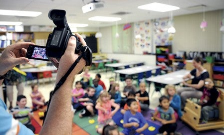 Ryan Mayer films Woodson Kindergarten Center student’s for the school’s annual video. Eric Johnson/photodesk@austindailyherald.com
