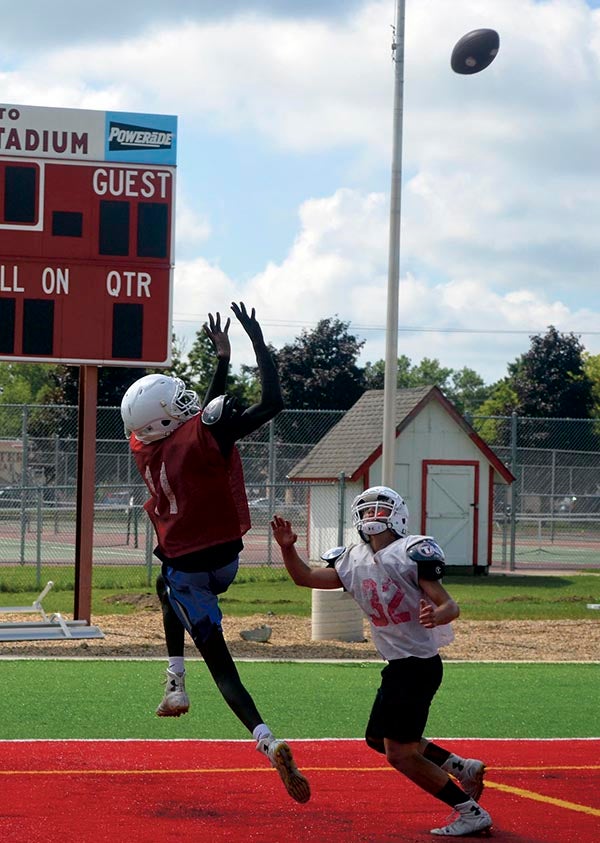 Duoth Gach goes up for a jump ball in practice for the Austin football team at Art Hass Stadium Wednesday. Rocky Hulne/sports@austindailyherald.com