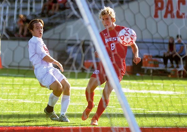 Matias Parada watches his first half shot find the back of the net against Mankato West in Art Hass Stadium Thursday. Rocky Hulne/sports@austindailyherald.com
