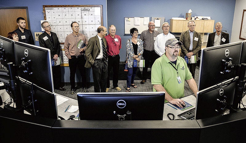 Dave White mans the Austin Utilities Service and Operations Center’s dispatch as a tour group comes through Wednesday night. Eric Johnson/photodesk@austindailyherald.com