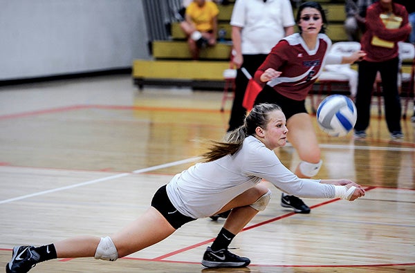 Austin’s Hannah Rasmussen lunges for a dig during game two against Rochester Mayo Thursday night in Packer Gym. Eric Johnson/photodesk@austindailyherald.com