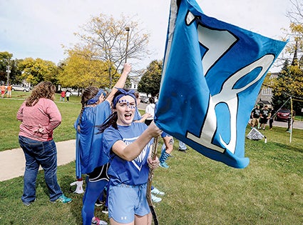 Junior Hannah Graves waves a flag during Battle of Connects Friday afternoon. 
