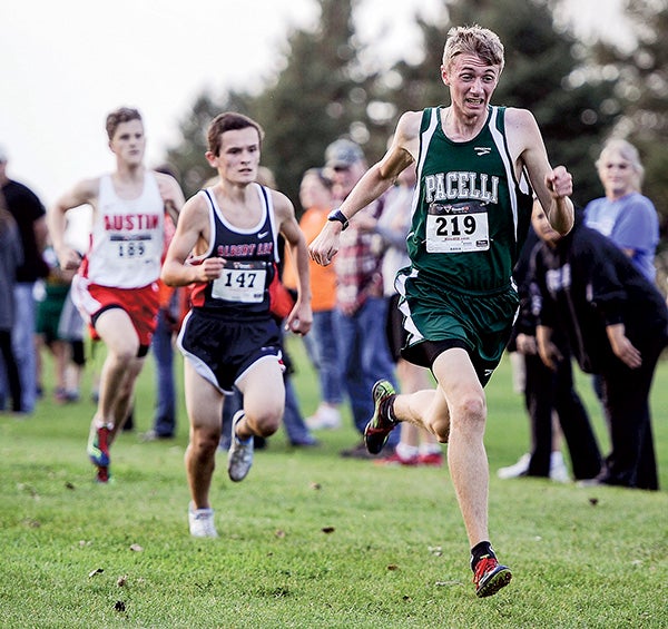 Pacelli’s Nathan Drees strides to the finish line during the varsity boys race in Austin this season. Herald File Photo