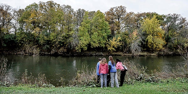Austin girl swimmers Ingrid Dolan Peterson, from left, Leticia Griffith, Jaeda Bekaeret and Joy Deng put garbage collected along the Cedar River into a garbage bag during the United Way of Mower County’s Day of Caring Saturday. Eric Johnson/photodesk@austindailyherald.com