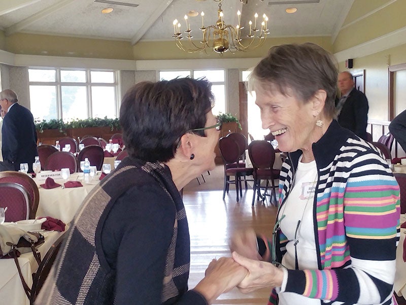 Belita Schindler, right, gets good wishes from Bonnie Rietz after she received the Lifetime Achievement Award from the Austin Area Chamber of Commerce on Wednesday.  Deb Nicklay/deb.nicklay@austindailyherald.com
