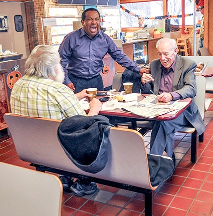 Jose Rivera, standing, shares a laugh with customers at the newly-opened Green Ranch, at 507 First St. N.W. The shop sells doughnuts, coffee, ice cream, soup and soon, tacos, enchiladas and burritos.